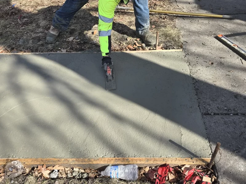 Crew pouring a new concrete sidewalk